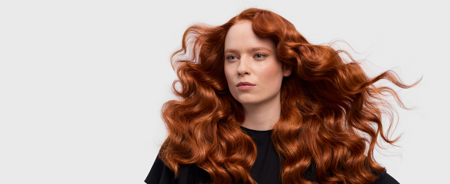 model with red wavy hair styled into Retro waves