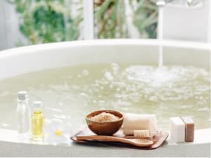 Running bath with fragrance oil and other haircare products made with bulk fragrances for cosmetics.