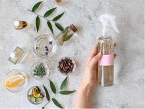 Woman holding skin care made with bulk fragrance oils for cosmetics, and plant parts to add in.