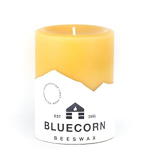 Yellow pure beeswax pillar candle with label