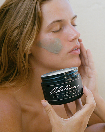 woman applying alitura clay mask organic exfoliation hydrating soothing skincare