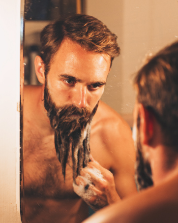 man washing his beard with Zeus Beard Shampoo