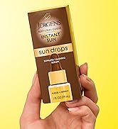 Woman holding Jergens Instant Sun Drops