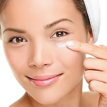 A happy woman using our eye moisturizer as a natural eye cream after shower