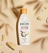 Bottle of Jergens Enriching Shea Butter on sand.