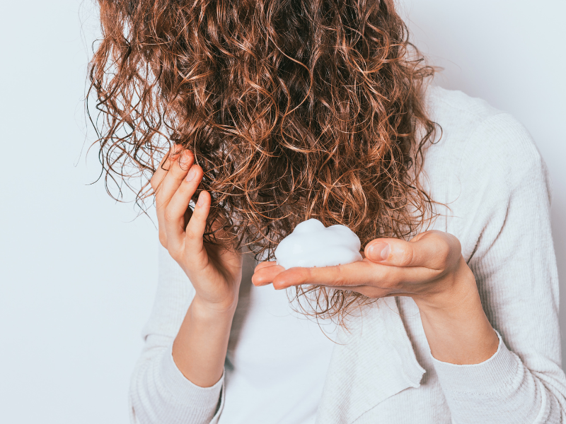 applying mousse to hair
