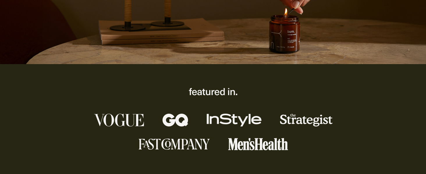 Massage candle with jojoba oil placed on table beside books showing massage oils for date night