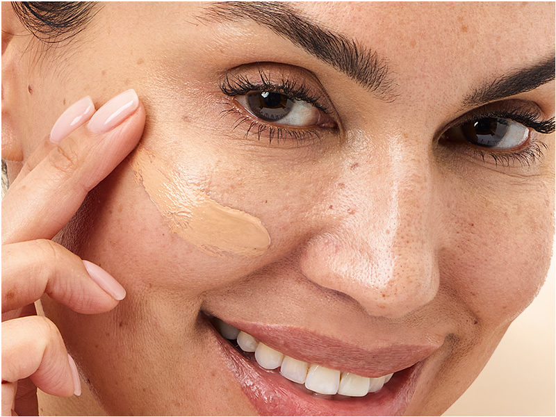 Model rubbing cream into face