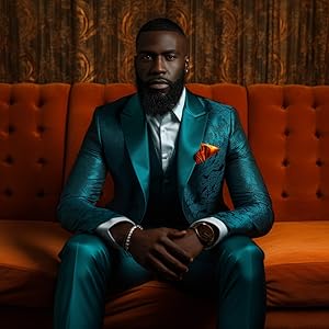 A black man sitting on an orange sofa