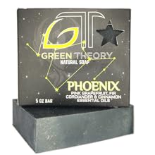 Green Theory Phoenix soap laying on its side with product packing standing on top