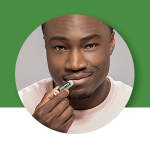 man using chapstick lip balm tube
