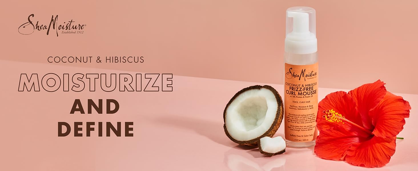 SheaMoisture Curl Mousse bottle with coconut pieces and hibiscus flower on light pink background.