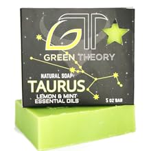 Green Theory Taurus soap laying on its side with the product packaging on top