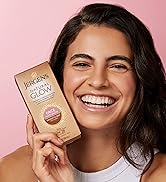 Woman holding a box of Jergens Natural Glow Daily Face Moisturizer