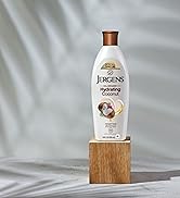 Bottle of Jergens Hydrating Coconut with a palm tree shadow