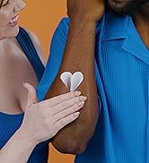 Woman rubbing lotion onto skin.