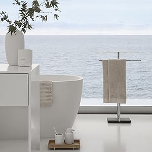 blomus Lily White FRAGA Candle shown with CEOLA vase, MENOTO Towel Stand and SONO Bath Accessories