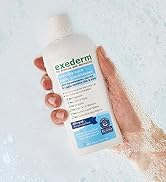 Exederm Conditioner being held by a hand submerged in a bathtub