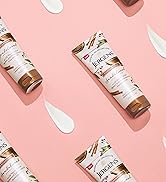 Jergens Sandalwood Body Butter bottles with lotion swatch