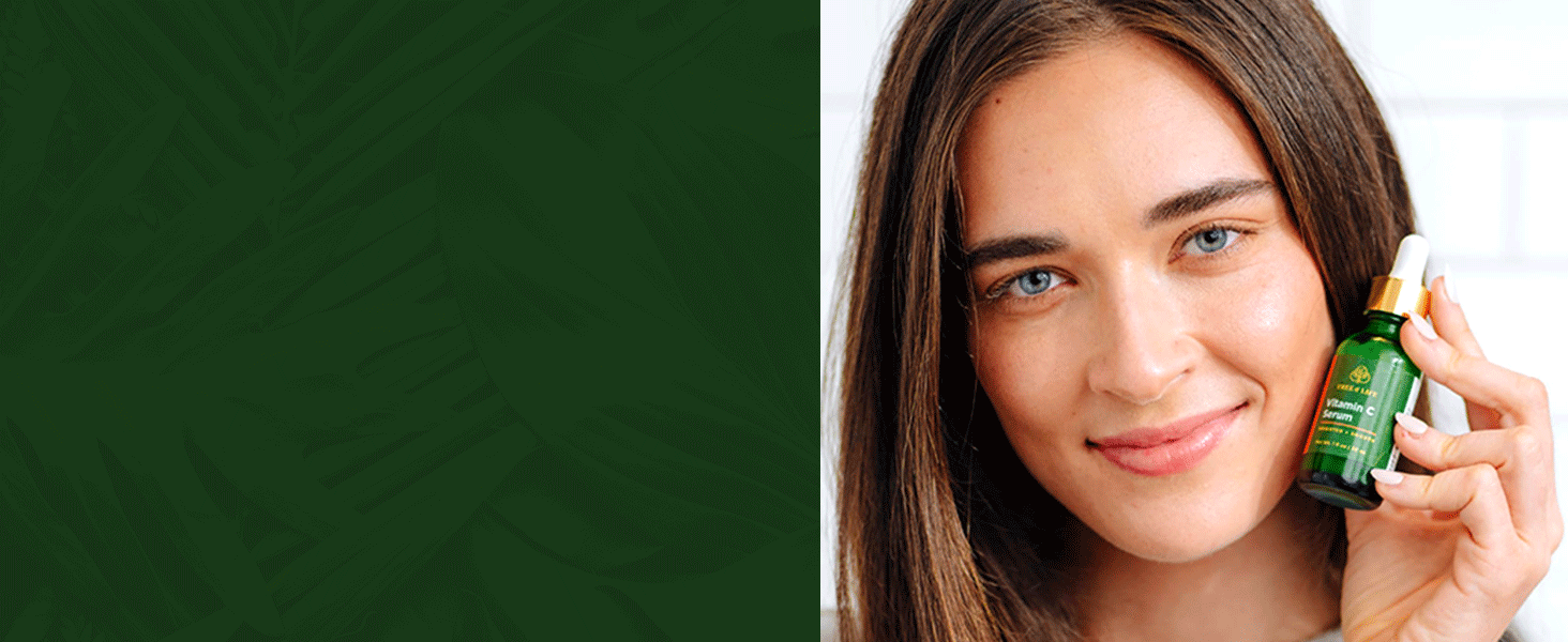 Young adult woman with clear skin holding Vit C serum