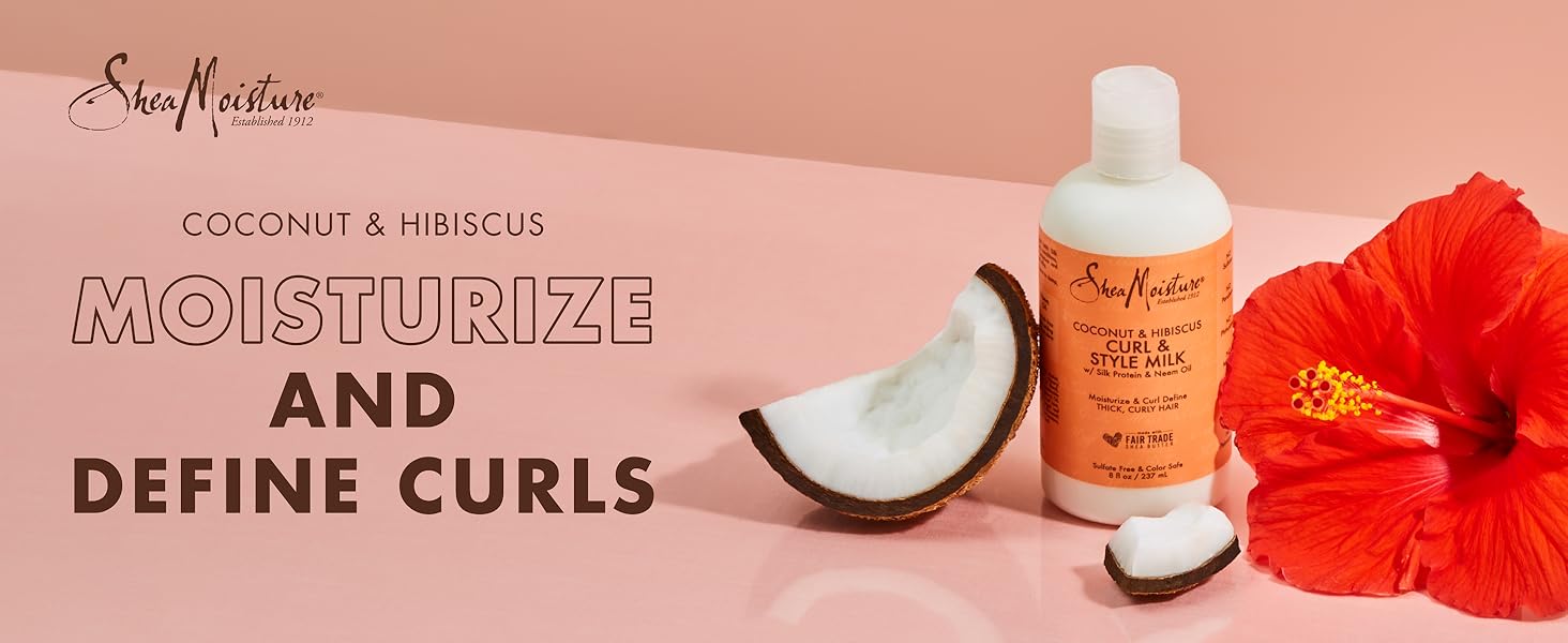SheaMoisture Style Milk bottle with coconut pieces and hibiscus flower on light pink background.