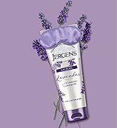 Bottle of Jergens Lavender Body Butter in front of lavender plant