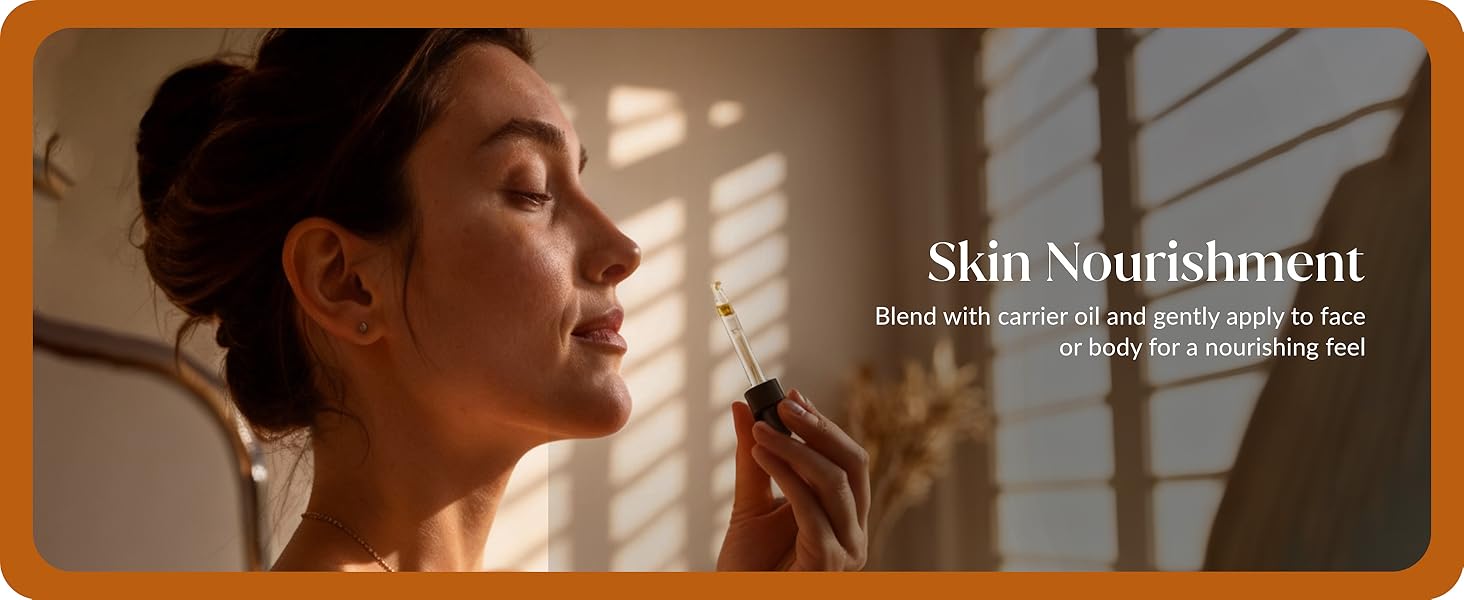 A lady showing her face after applying turmeric essential oil from the bottle for skincare