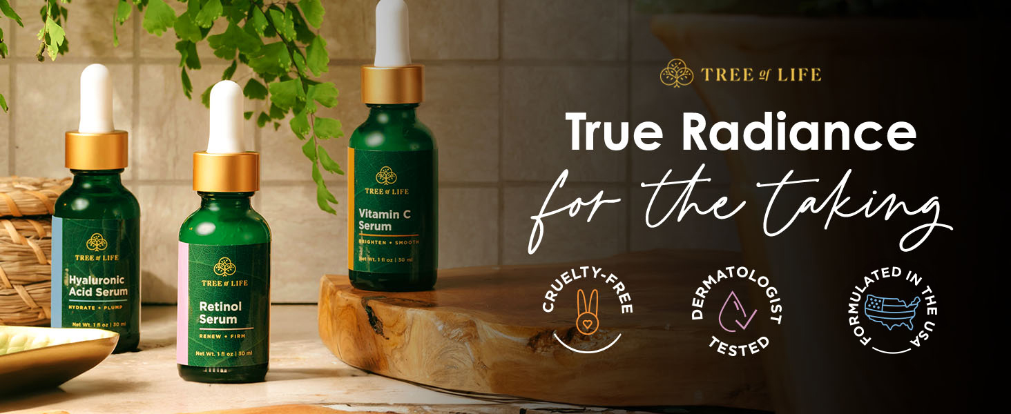 tree of life hyaluronic acid serum, retinol serum, vitamin c serum on a wooden board