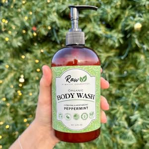 Woman holding organic peppermint body wash with a Christmas tree in the background