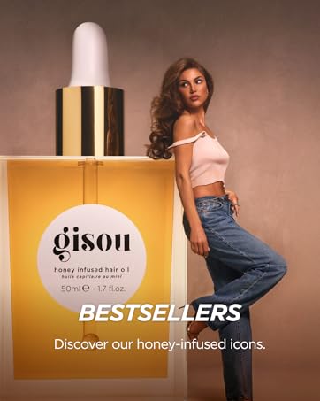 Negin posing next to oversized Gisou Hair Oil bottle, showcasing hero product of the brand