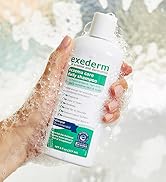 Exederm Shampoo being held by a hand in a shower