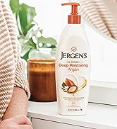 Jergens Deep Restoring Argan next to a candle
