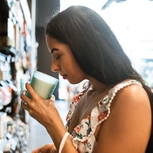 Woman smelling candle