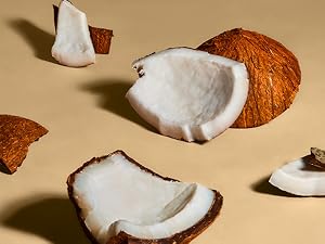 Coconut pieces on light brown background.