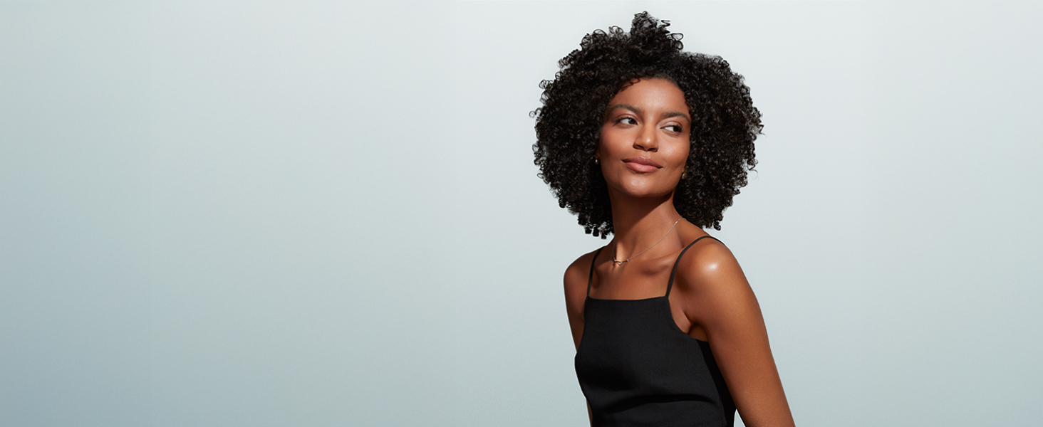 Woman with healthy, moisture and strong curly hair. 