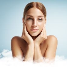 Woman with clear, healthy skin touching face gently with both hands