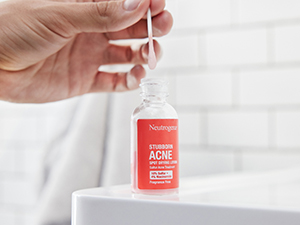 Glass bottle of Stubborn Acne Spot Drying Lotion with cotton swab