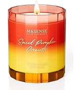 M&SENSE scented candle in orange-yellow ombre glass container. Label reads 'Spiced Pumpkin Amaretto'. Lit candle visible inside.