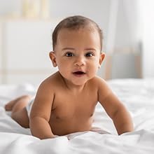 Black American baby lying on his stomach, smiling