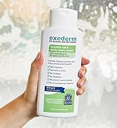 Exederm Body Wash for Eczema & Dermatitis bottle held by hand in front of glass shower door