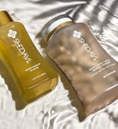 Flat lay image of Iconic Duo Hair Growth Elixir Oil Serum and Hair Growth Vitamins in Water 