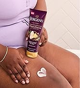 Woman rubbing lotion onto her leg