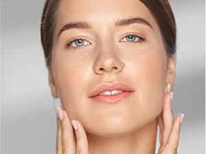 Woman applies retinol cream to face