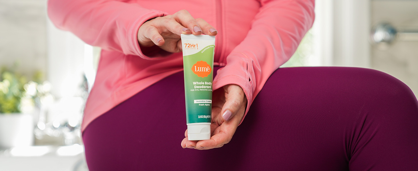 Lumē Cream Tube Deodorant in Fresh Alpine being held with two hands