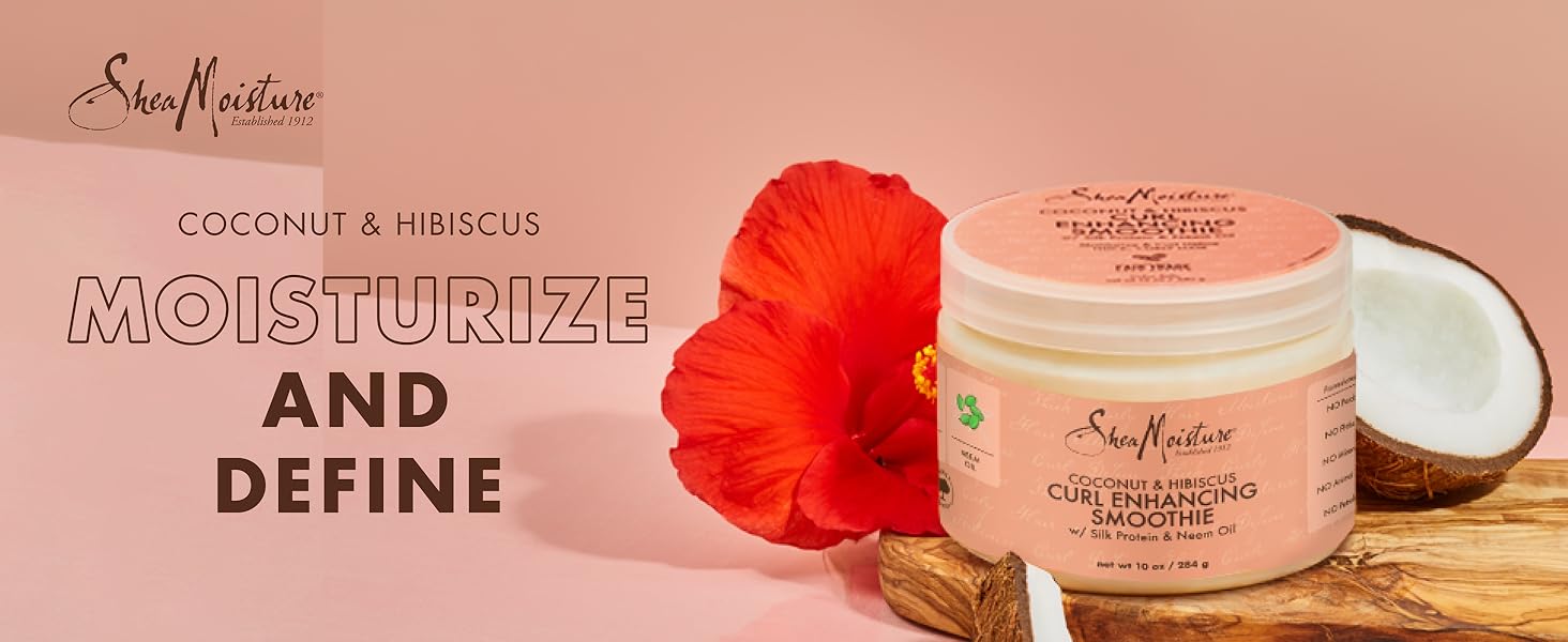 SheaMoisture smoothie container with coconut pieces and hibiscus flower on light pink background.