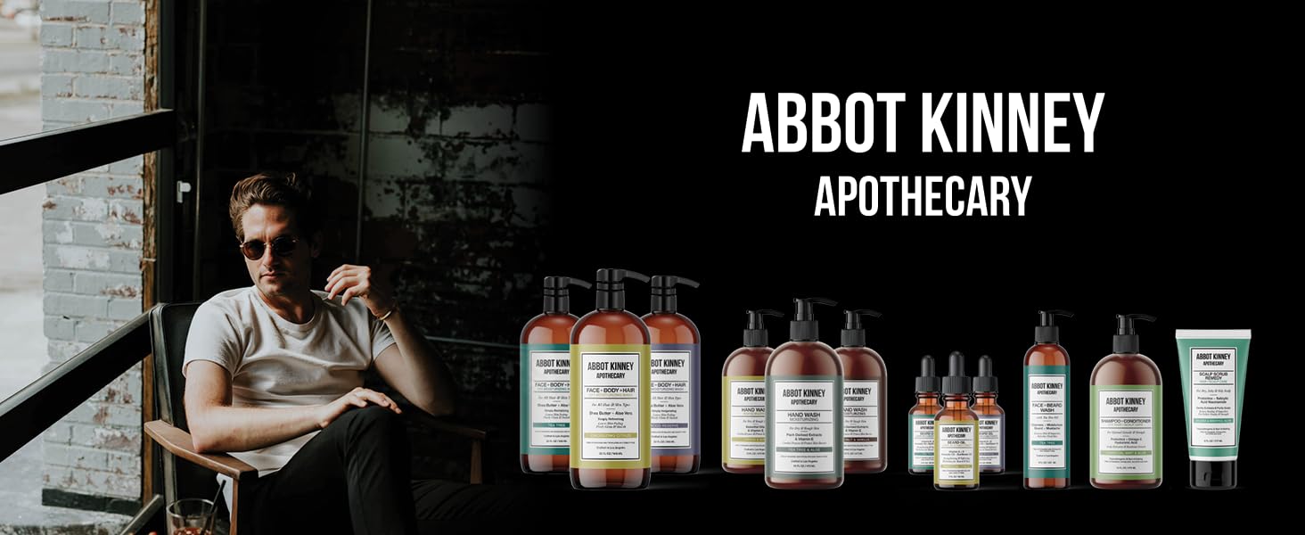 man sitting in rugged chair next to  full collection of hair shampoo and beard wash items for men