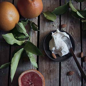 Freshly made lotion on table with grapefruit