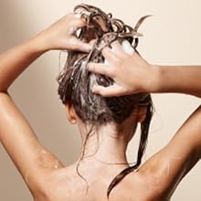 Child washing hair with Suave Minions 3-in-1, hands lather hair, soap suds visible on shoulders.