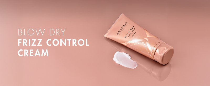 Blow Dry bottle on top of a rose gold surface, next to a small drop of cream. Text on the left. 