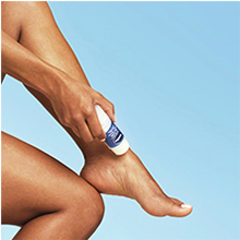 Person applying Vaseline stick on legs